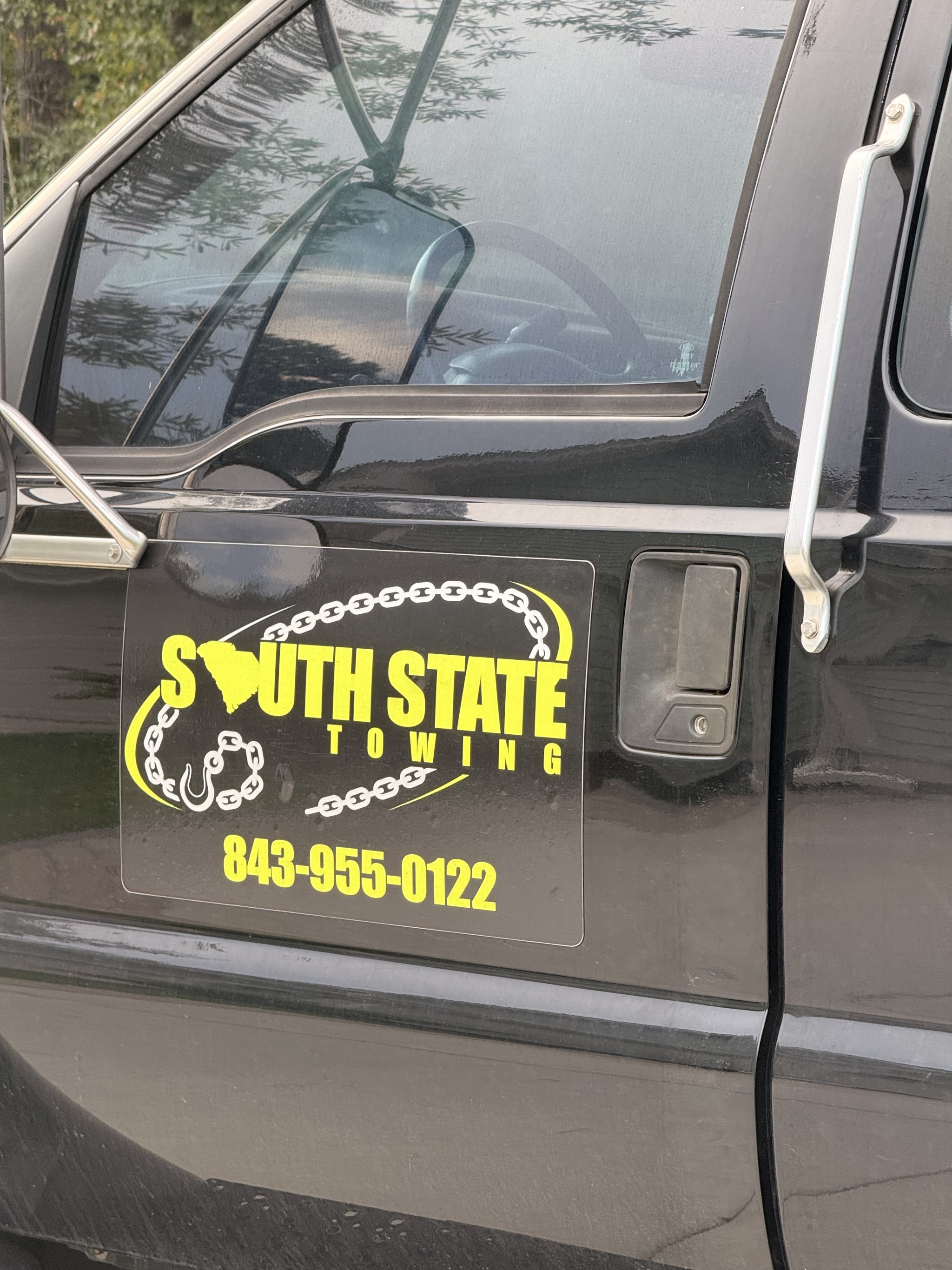 The South State Towing logo and phone number on our truck door