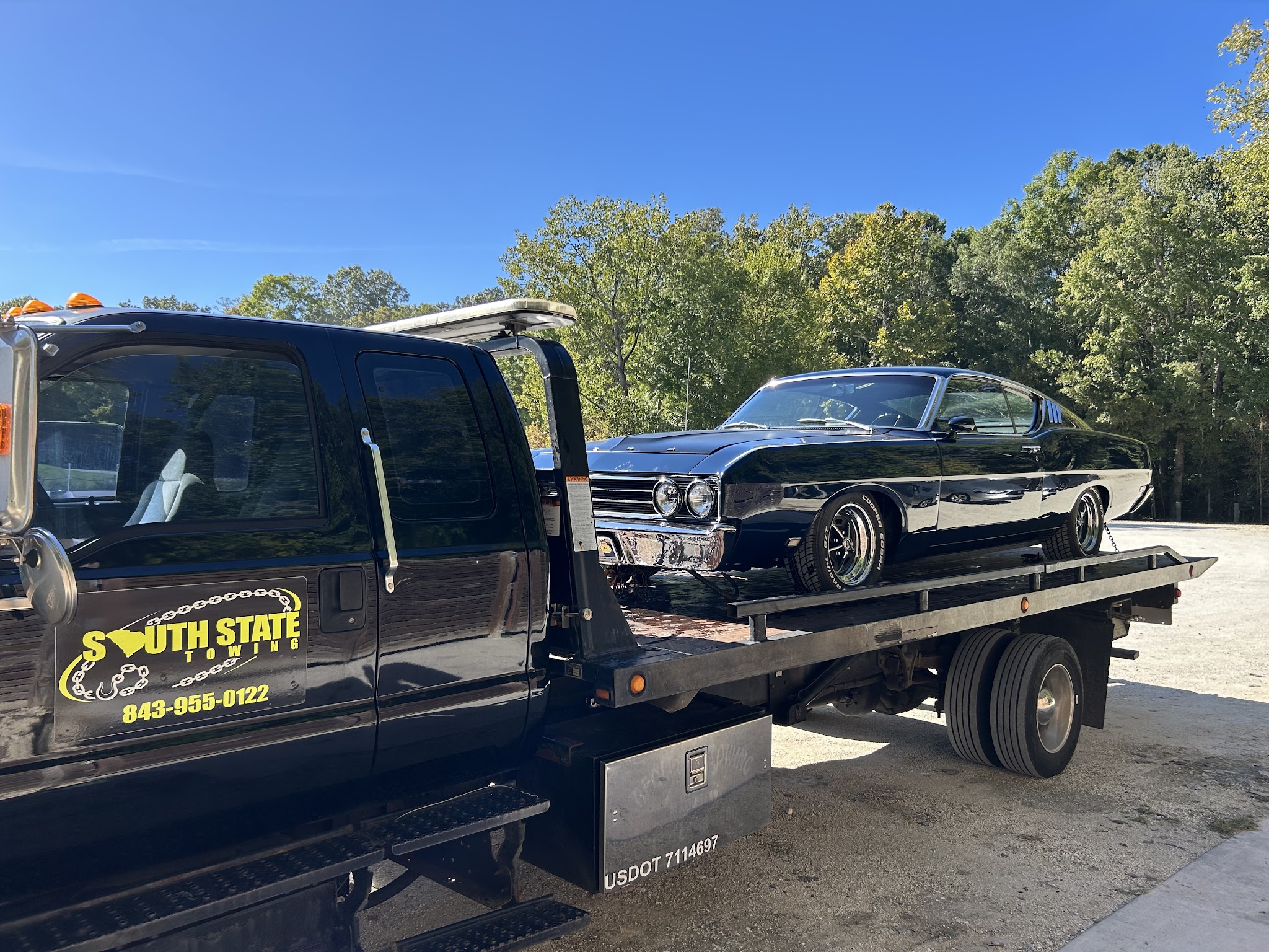 A classic car chained down on our flatbed