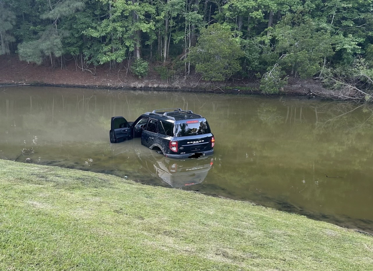 A Ford Bronco Sport sitting in a pond before recovery